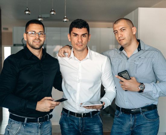 Group of diverse people in a bright, spacious room, smiling and looking relaxed.